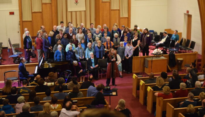 Chorus singing to congregation in sanctuary