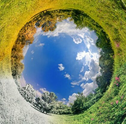 circle of sky surrounded by landscapes in various seasons